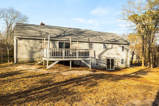 back of property featuring a chimney and a wooden deck