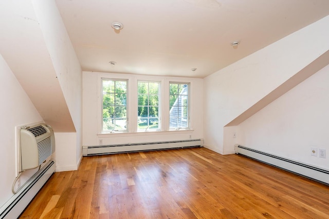 40 Thacher Shore Rd, Yarmouth Port, MA 02675 - additional living space with a baseboard heating unit, wood finished floors, and baseboards