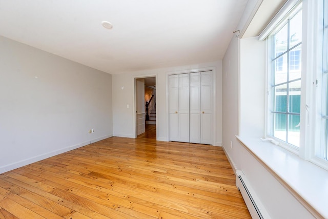 40 Thacher Shore Rd, Yarmouth Port, MA 02675 - unfurnished bedroom with light wood-type flooring, multiple windows, and baseboards