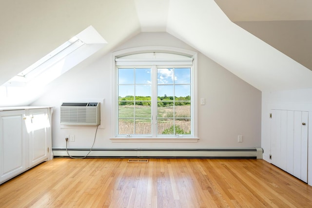 40 Thacher Shore Rd, Yarmouth Port, MA 02675 - additional living space featuring a skylight, a wall mounted air conditioner, vaulted ceiling, light wood finished floors, and plenty of natural light