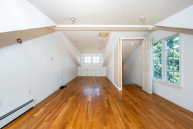 40 Thacher Shore Rd, Yarmouth Port, MA 02675 - bonus room with a baseboard heating unit, wood finished floors, vaulted ceiling, and baseboards