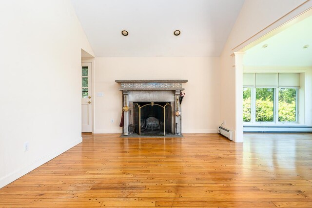 40 Thacher Shore Rd, Yarmouth Port, MA 02675 - unfurnished living room with vaulted ceiling, hardwood / wood-style flooring, baseboard heating, a fireplace with flush hearth, and baseboards
