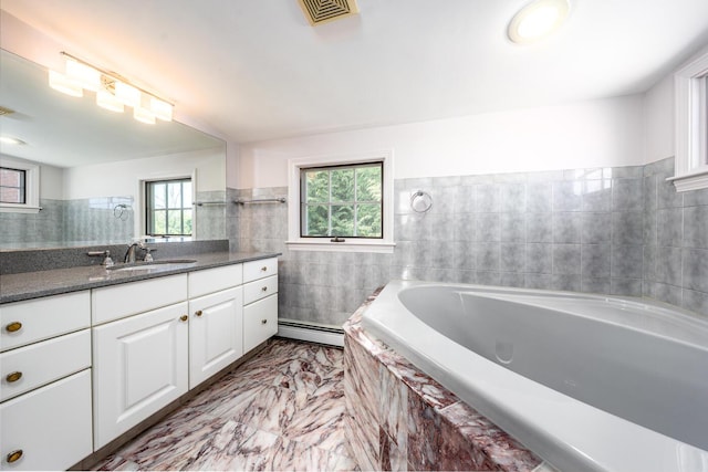 40 Thacher Shore Rd, Yarmouth Port, MA 02675 - full bathroom featuring a baseboard radiator, tile walls, plenty of natural light, a bath, and vanity
