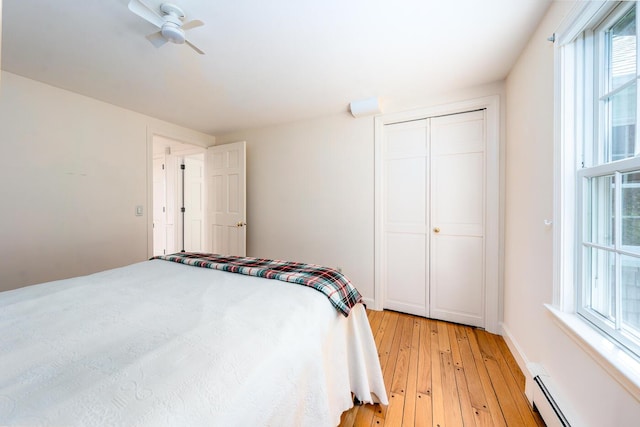 40 Thacher Shore Rd, Yarmouth Port, MA 02675 - bedroom with baseboard heating, light wood-style floors, and a closet