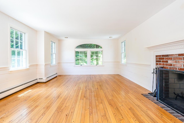 40 Thacher Shore Rd, Yarmouth Port, MA 02675 - unfurnished living room featuring wood-type flooring, a fireplace, plenty of natural light, and wainscoting