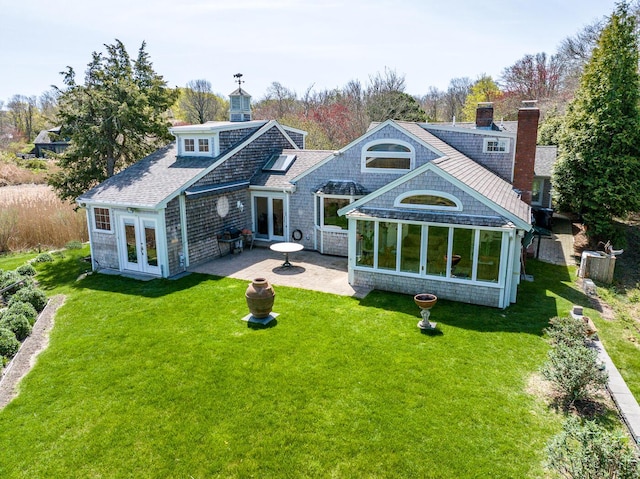 40 Thacher Shore Rd, Yarmouth Port, MA 02675 - rear view of house with french doors, a patio, a lawn, and a chimney