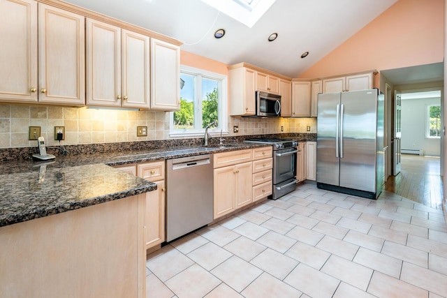40 Thacher Shore Rd, Yarmouth Port, MA 02675 - kitchen featuring appliances with stainless steel finishes, a skylight, light brown cabinetry, a sink, and vaulted ceiling