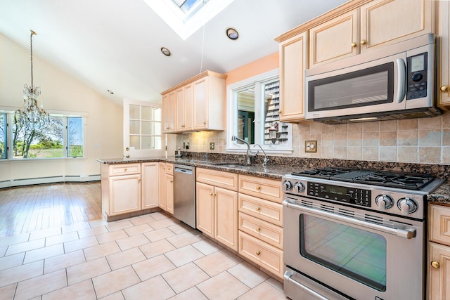 40 Thacher Shore Rd, Yarmouth Port, MA 02675 - kitchen with stainless steel appliances, vaulted ceiling, light brown cabinets, and tasteful backsplash