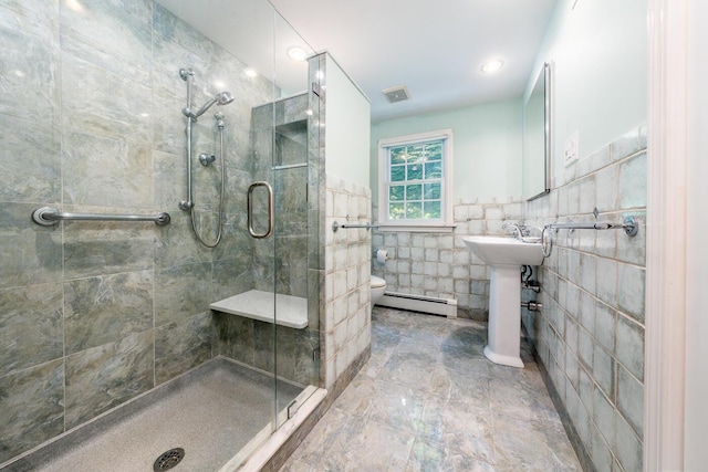 40 Thacher Shore Rd, Yarmouth Port, MA 02675 - bathroom featuring a baseboard heating unit, a shower stall, toilet, tile walls, and a sink