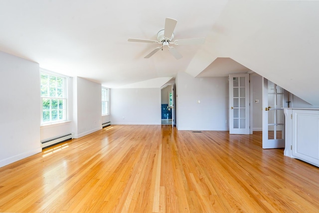 40 Thacher Shore Rd, Yarmouth Port, MA 02675 - unfurnished living room featuring a baseboard radiator, baseboard heating, vaulted ceiling, ceiling fan, and light wood-type flooring