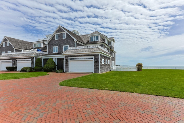 view of front of property featuring decorative driveway and a garage