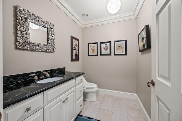 bathroom with crown molding, toilet, vanity, tile patterned flooring, and baseboards