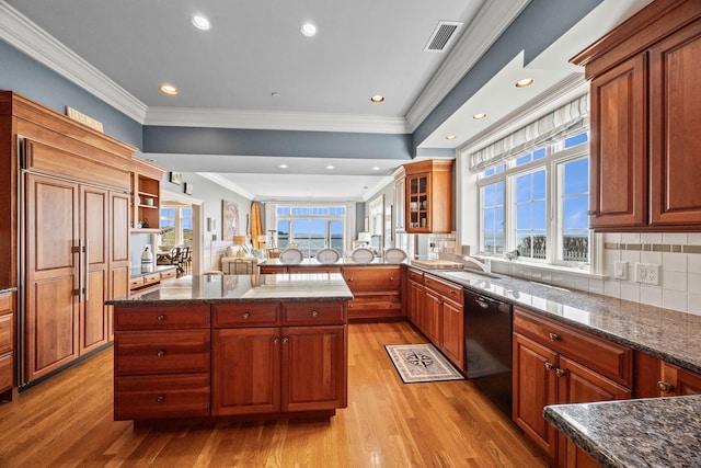 kitchen with dishwasher, light wood-type flooring, a sink, crown molding, and dark stone countertops
