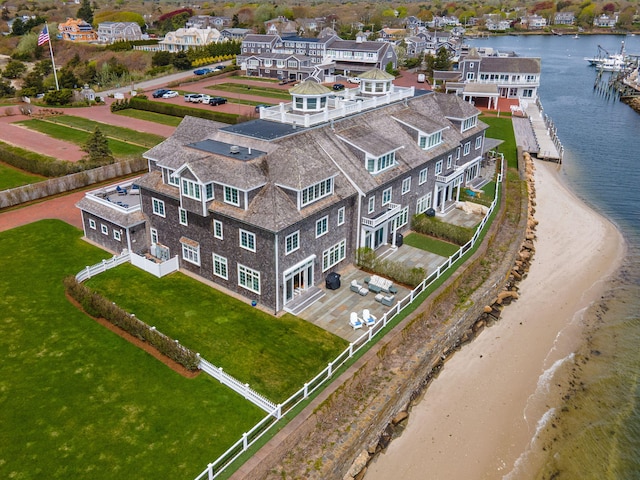 aerial view of property and surrounding area with a nearby body of water