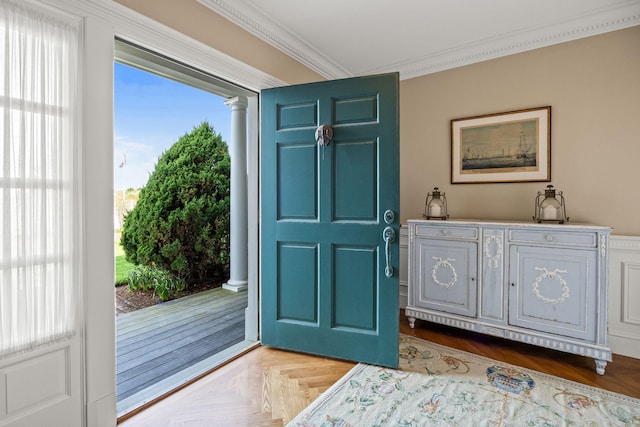 doorway to outside featuring crown molding and ornate columns