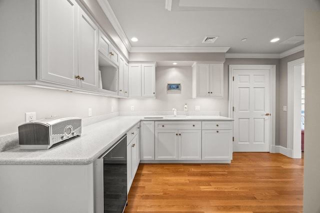 kitchen with beverage cooler, white cabinetry, ornamental molding, recessed lighting, and light wood-style flooring