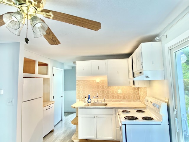 kitchen featuring light hardwood / wood-style flooring, sink, backsplash, white cabinets, and white appliances