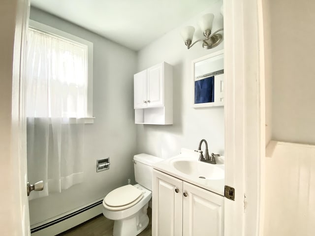 bathroom with toilet, a baseboard heating unit, and vanity