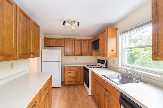 17 Harbor Hill Dr, Bourne, MA 02532 - kitchen featuring white appliances, light wood finished floors, light countertops, and brown cabinets