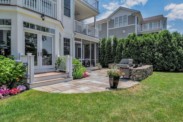 66 Simons Rd Unit A, Mashpee, MA 02649 - rear view of property featuring a yard, a patio, a sunroom, french doors, and a balcony