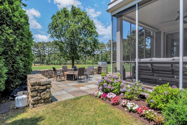 66 Simons Rd Unit A, Mashpee, MA 02649 - view of grassy yard featuring a patio area, an outdoor kitchen, ceiling fan, and a fire pit