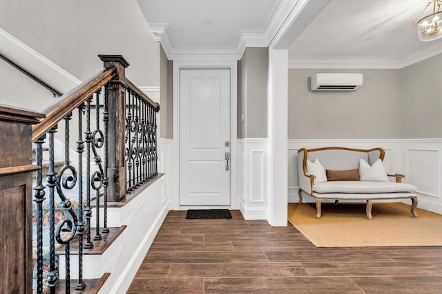 66 Simons Rd Unit A, Mashpee, MA 02649 - entrance foyer with a wall unit AC, a wainscoted wall, crown molding, dark wood-style flooring, and a decorative wall