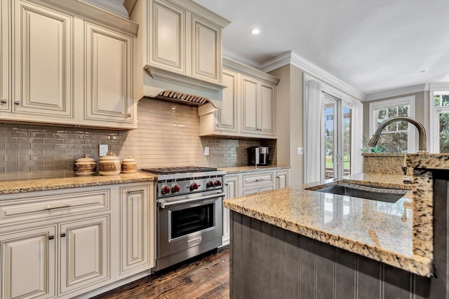 66 Simons Rd Unit A, Mashpee, MA 02649 - kitchen with luxury range, cream cabinets, dark wood-style floors, backsplash, and light stone countertops