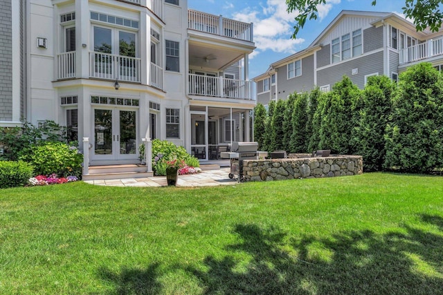 66 Simons Rd Unit A, Mashpee, MA 02649 - rear view of property with french doors, a balcony, a yard, and a sunroom