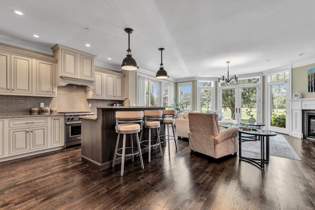 66 Simons Rd Unit A, Mashpee, MA 02649 - kitchen featuring cream cabinetry, high end stainless steel range, open floor plan, ornamental molding, and dark wood finished floors