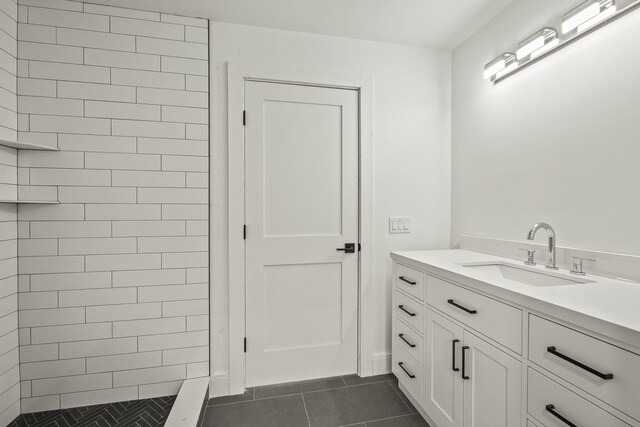 bathroom featuring tile patterned floors, vanity, and tiled shower