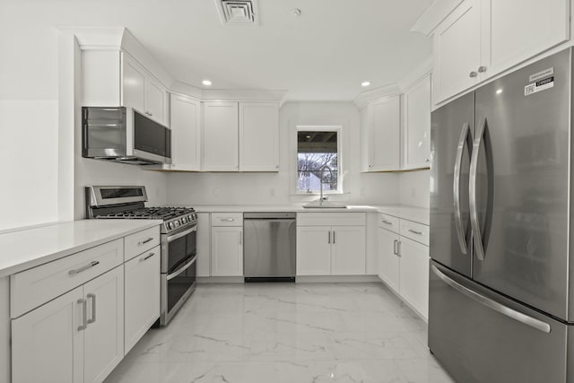 46-A Harry Kemp Way Unit 2, Provincetown, MA 02657 - kitchen featuring appliances with stainless steel finishes, light marble finish flooring, recessed lighting, white cabinets, and light countertops