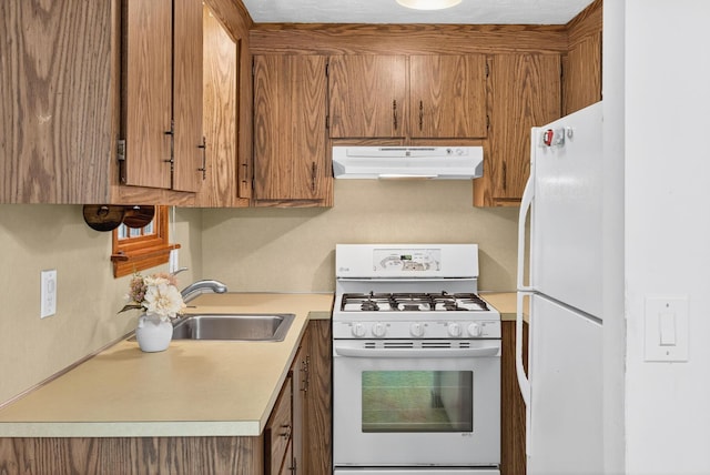 153 Blackthorn Rd, Marstons Mills, MA 02648 - kitchen with white appliances, under cabinet range hood, light countertops, and brown cabinetry