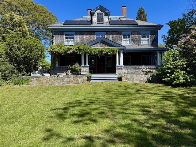10 Quissett Ave, Woods Hole, MA 02543 - shingle-style home with covered porch, roof mounted solar panels, and a front yard