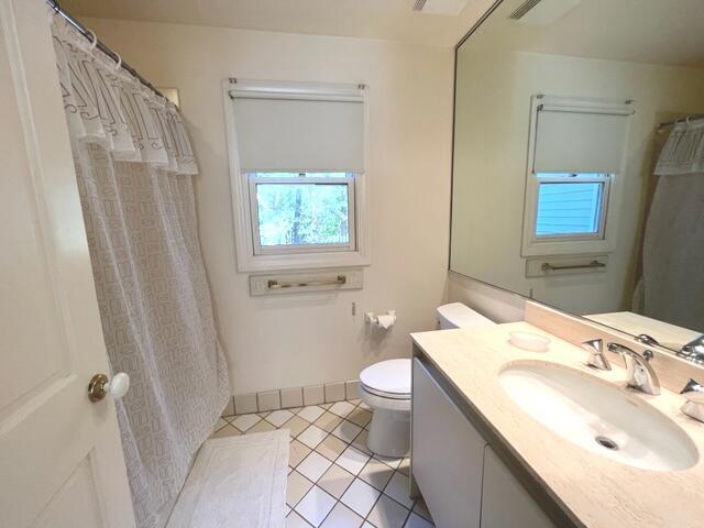 bathroom with vanity, toilet, tile patterned floors, and a shower with shower curtain