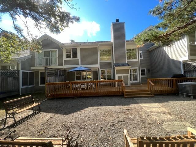 back of property with a wooden deck and central air condition unit