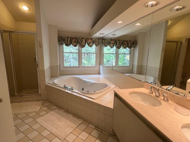 bathroom featuring tile patterned floors, vanity, and separate shower and tub