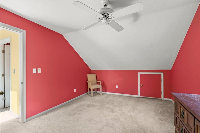 bonus room with light carpet, vaulted ceiling, and ceiling fan