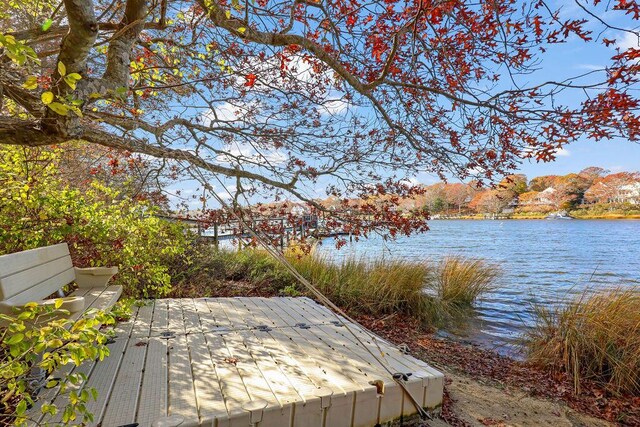 wooden terrace with a water and mountain view