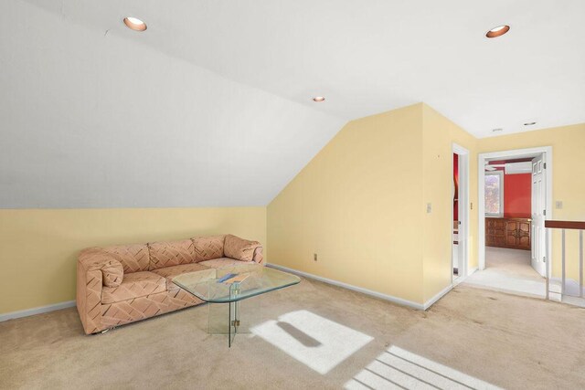 unfurnished living room with light carpet and lofted ceiling