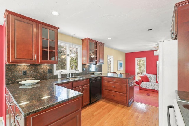 kitchen with kitchen peninsula, pendant lighting, light hardwood / wood-style flooring, dishwasher, and sink