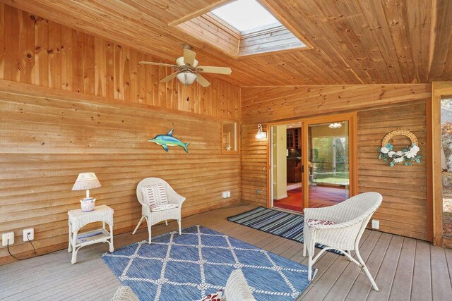 living area with wood-type flooring, vaulted ceiling with skylight, and wood ceiling