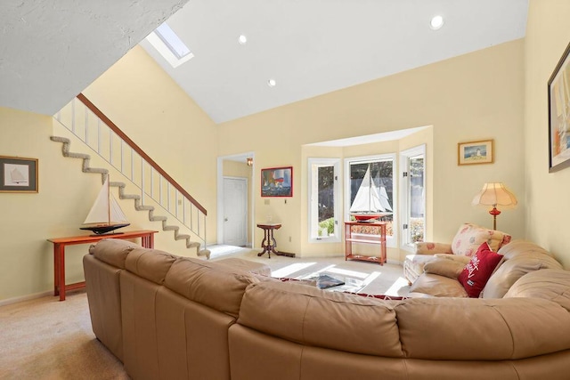 living room with light carpet, high vaulted ceiling, and a skylight