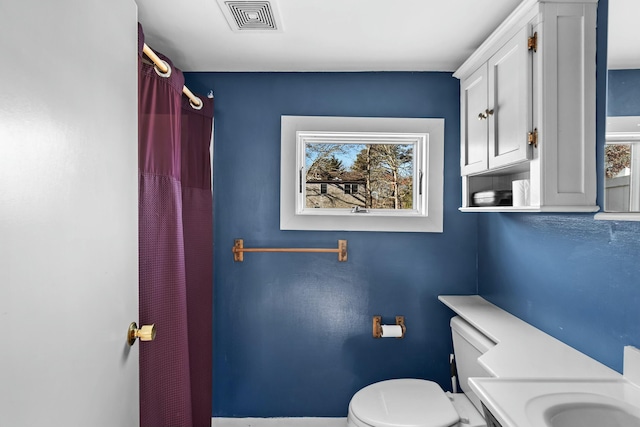 bathroom with curtained shower and toilet