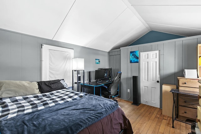 bedroom featuring lofted ceiling and light hardwood / wood-style flooring