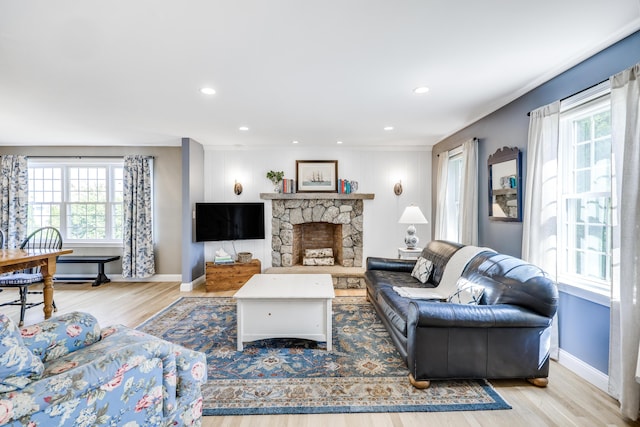 living room with light hardwood / wood-style floors and a fireplace