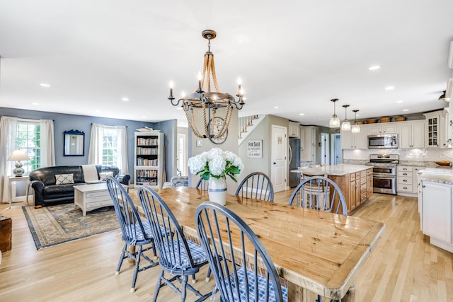 dining room featuring light hardwood / wood-style flooring and an inviting chandelier