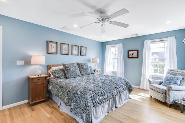 bedroom with light hardwood / wood-style flooring and ceiling fan