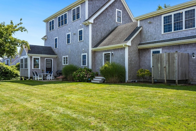 rear view of property featuring a yard