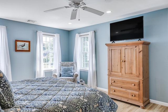 bedroom with ceiling fan and light hardwood / wood-style floors