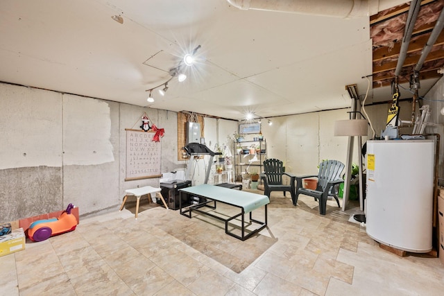 basement featuring track lighting and water heater